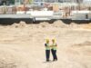 Project manager overseeing built to suit commercial project management on construction site