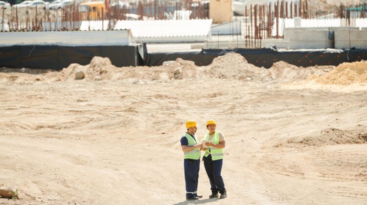 Project manager overseeing built to suit commercial project management on construction site