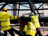 Built to suit commercial project management with project manager reviewing construction blueprints