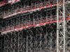 Built to suit commercial project management with project manager reviewing construction plans
