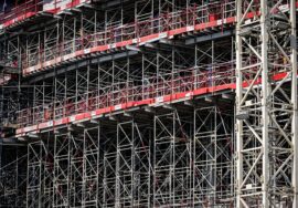 Built to suit commercial project management with project manager reviewing construction plans