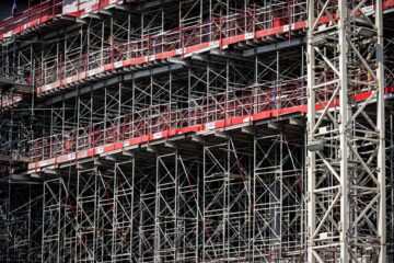 Built to suit commercial project management with project manager reviewing construction plans