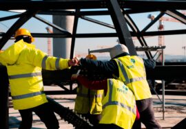 Built to suit commercial project management with project manager reviewing construction blueprints