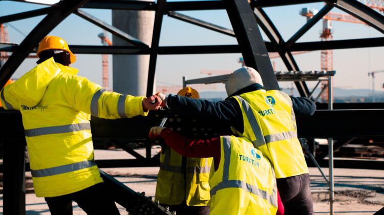 Built to suit commercial project management with project manager reviewing construction blueprints