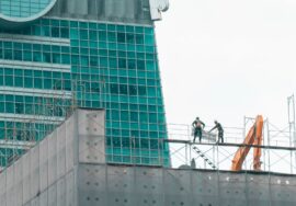 Commercial construction project manager inspecting blueprint at construction site