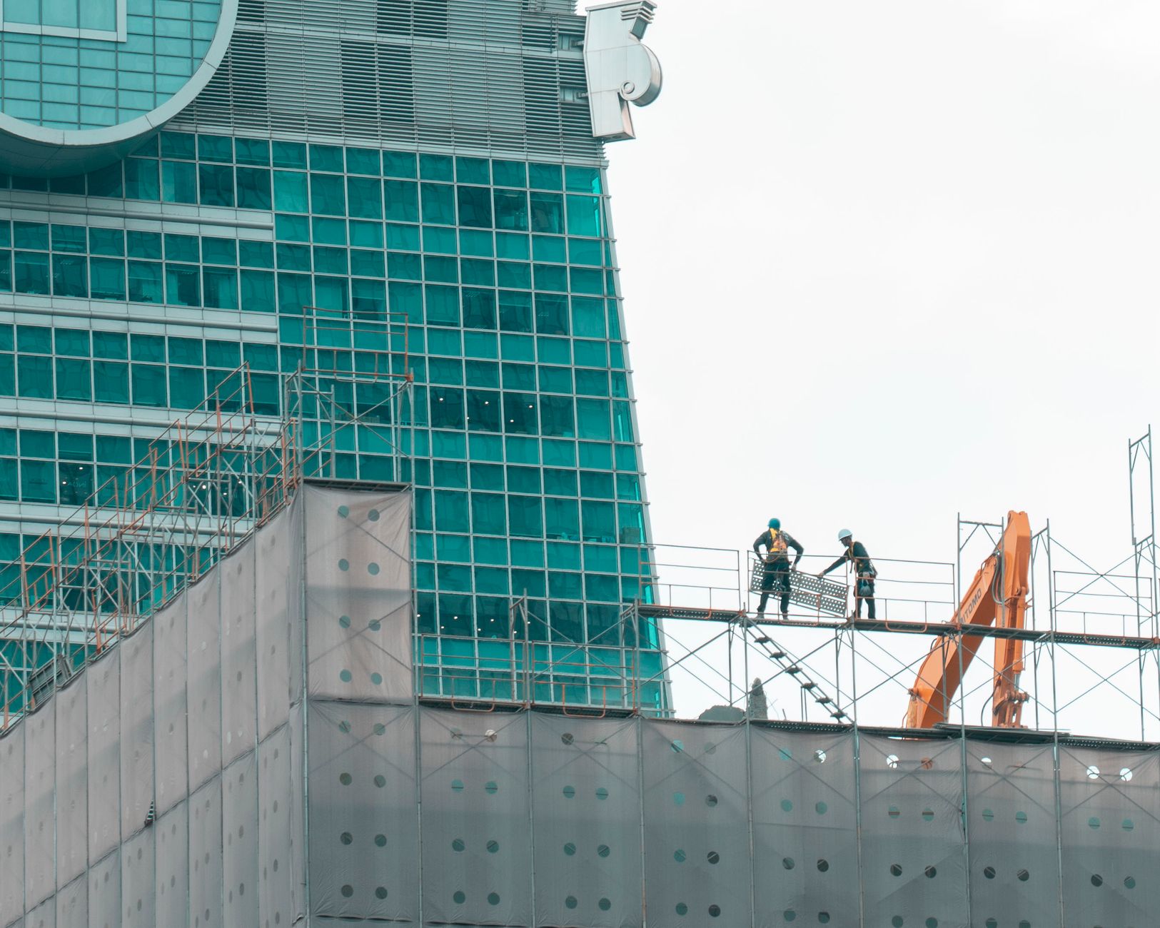 Commercial construction project manager inspecting blueprint at construction site