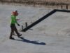 Construction audit importance in project success with project manager reviewing site blueprint