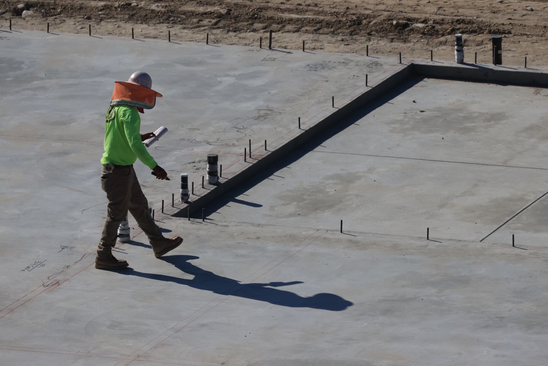 Construction audit importance in project success with project manager reviewing site blueprint