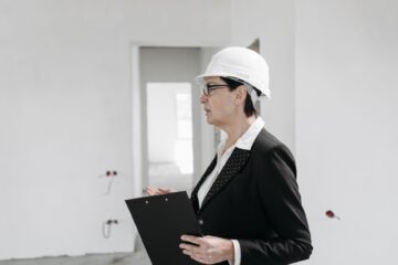 Project manager conducting construction audit checklist on commercial building site