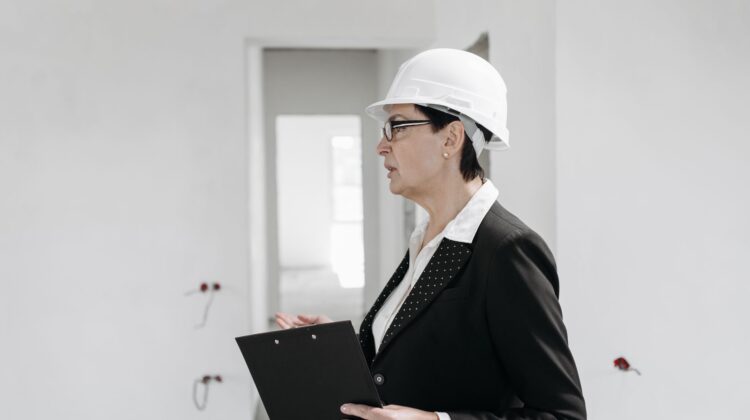 Project manager conducting construction audit checklist on commercial building site