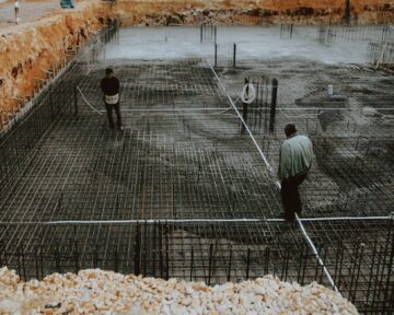 construction project management consultant reviewing blueprint for construction excellence