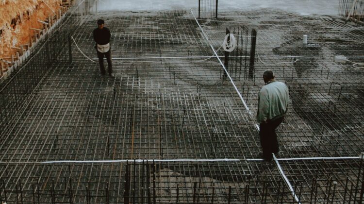 construction project management consultant reviewing blueprint for construction excellence