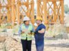 construction site showing operational performance in construction project management with project manager and blueprint