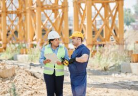 construction site showing operational performance in construction project management with project manager and blueprint