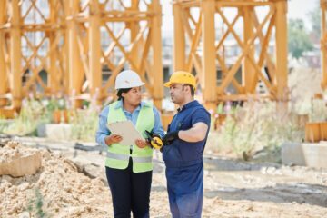 construction site showing operational performance in construction project management with project manager and blueprint