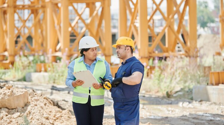 construction site showing operational performance in construction project management with project manager and blueprint