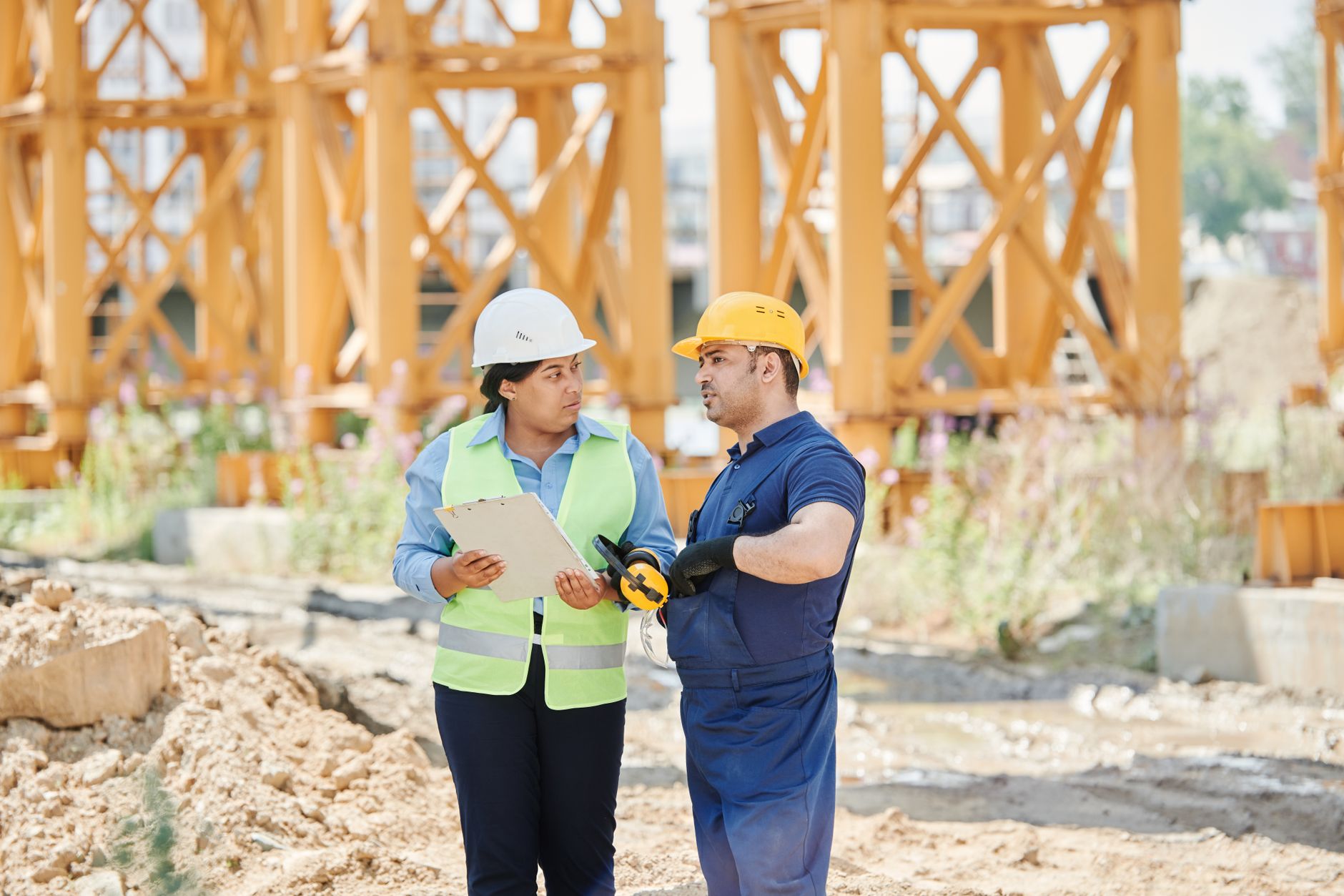 construction site showing operational performance in construction project management with project manager and blueprint