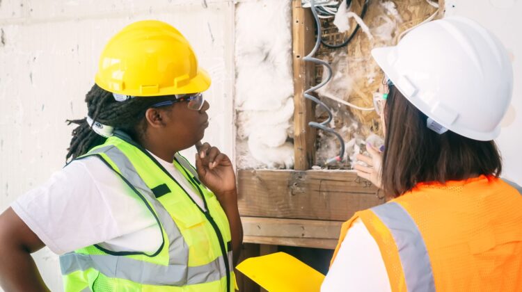 construction audit site inspection with project manager reviewing blueprint