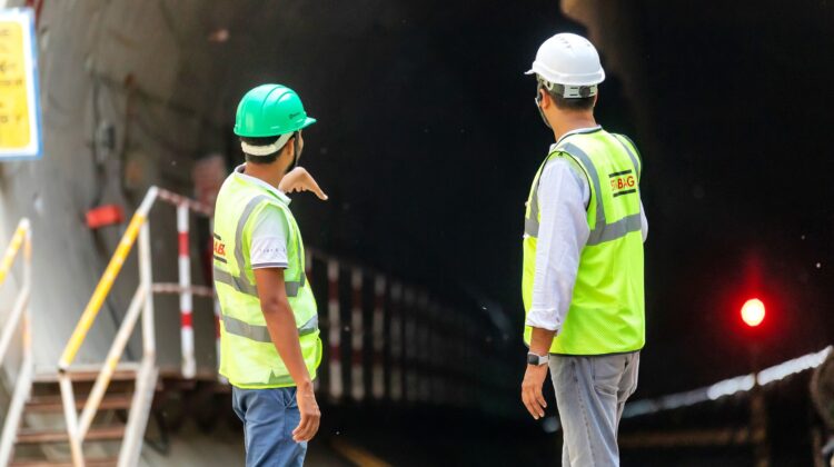 construction audit site inspection with project manager reviewing blueprint