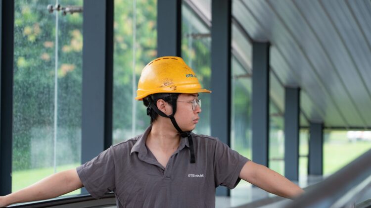 construction audit at commercial construction site with project manager reviewing blueprints