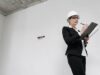 construction management at a commercial construction site with project manager reviewing blueprints