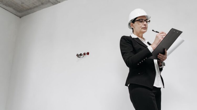 construction management at a commercial construction site with project manager reviewing blueprints