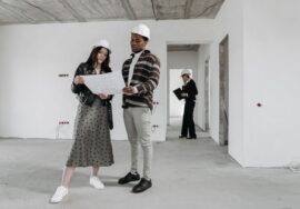 construction project management consultant reviewing commercial construction site plans