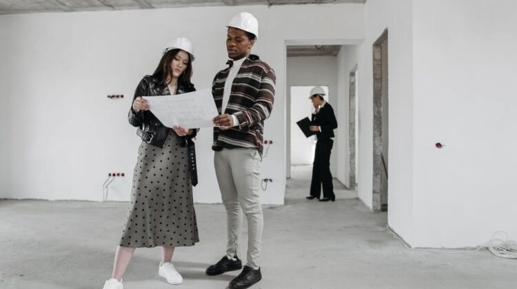 construction project management consultant reviewing commercial construction site plans