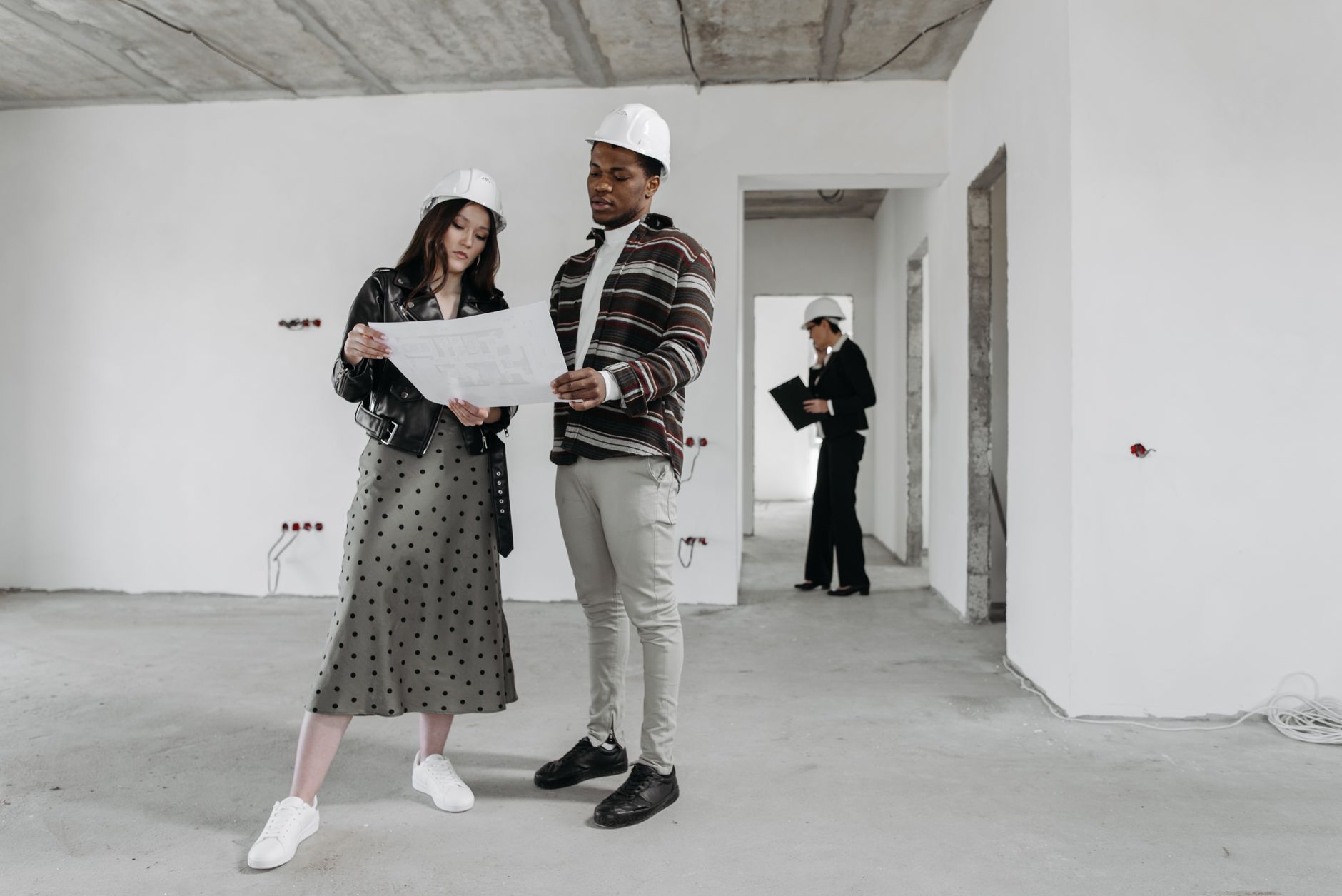 construction project management consultant reviewing commercial construction site plans