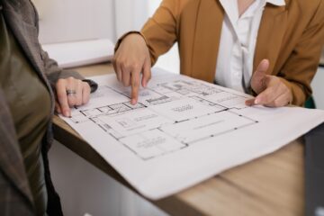 cost management in commercial construction project with site manager and blueprints