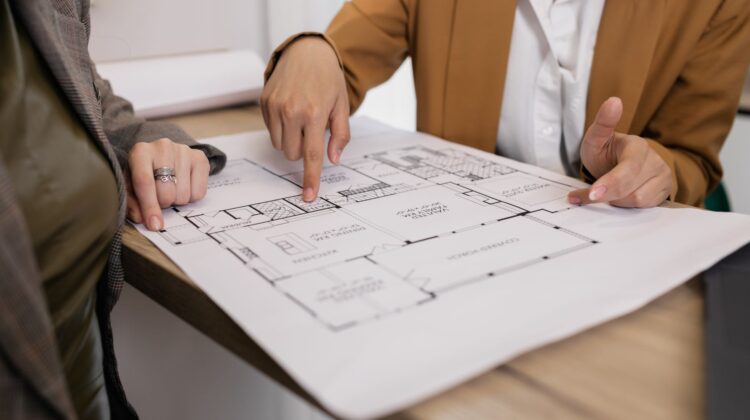cost management in commercial construction project with site manager and blueprints