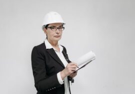 Built-to-suit corporate office fitout project manager reviewing blueprints on site