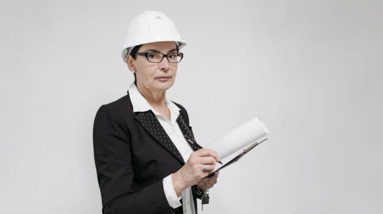 Built-to-suit corporate office fitout project manager reviewing blueprints on site