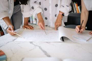 construction reporting for corporate office fitouts showing project manager reviewing blueprint