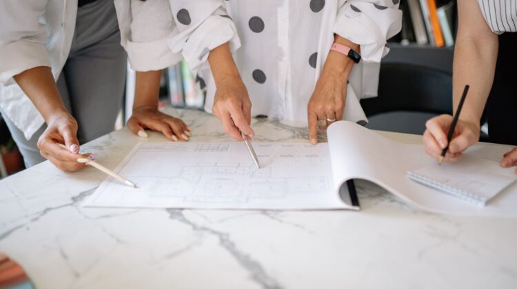 construction reporting for corporate office fitouts showing project manager reviewing blueprint