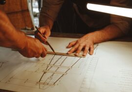 Corporate office fitout design management with project manager reviewing blueprints