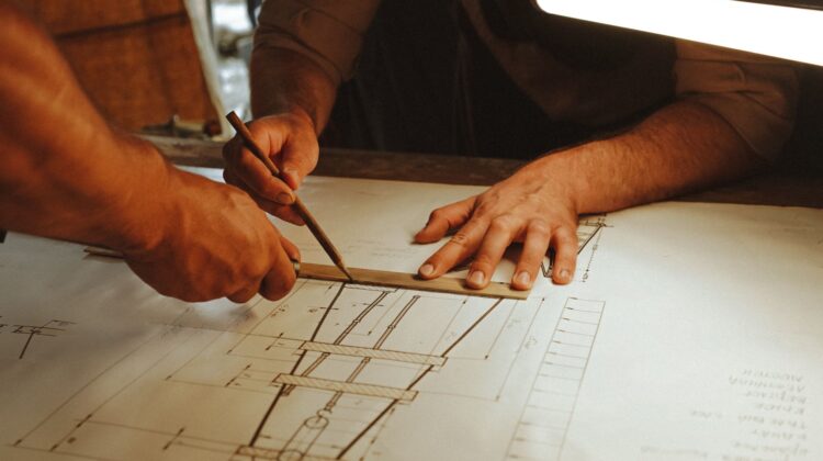 Corporate office fitout design management with project manager reviewing blueprints