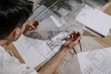 Corporate fitouts project manager reviewing construction blueprint on site