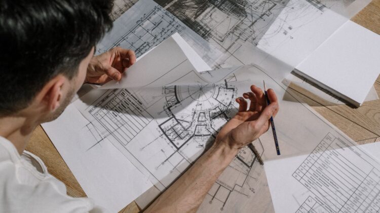 Corporate fitouts project manager reviewing construction blueprint on site