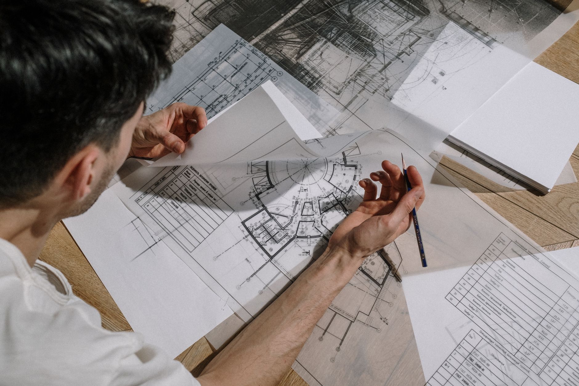 Corporate fitouts project manager reviewing construction blueprint on site