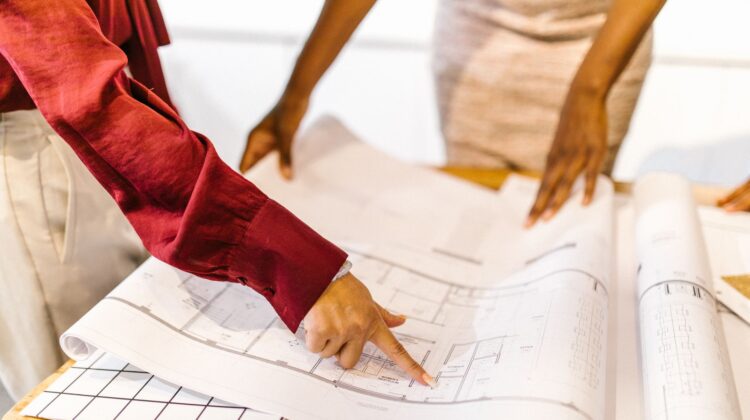 Project manager reviewing plans for interior fitouts in a corporate office