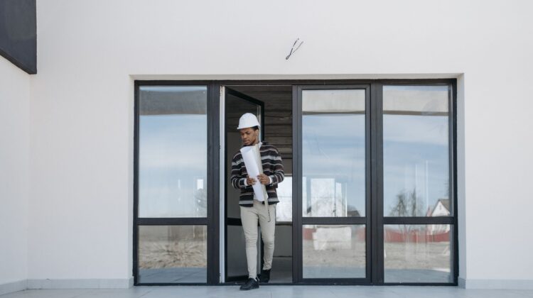 Project closeout process with construction site manager reviewing plans