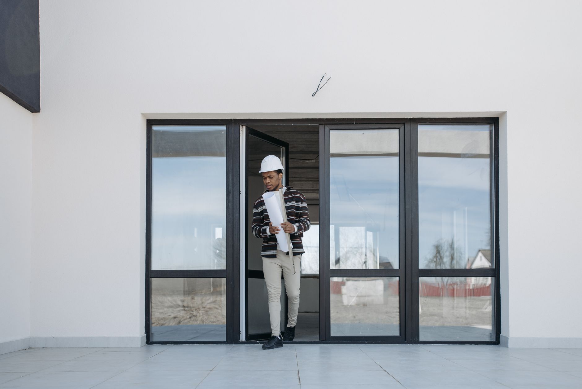 Project closeout process with construction site manager reviewing plans