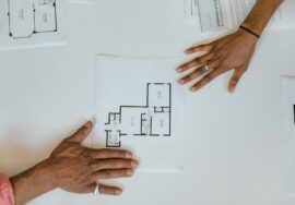 Vendor management in construction project tracking with project manager reviewing blueprints