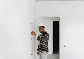 Office renovation site inspection with project manager overseeing construction and blueprint