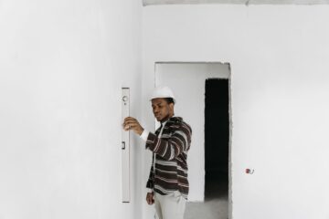Office renovation site inspection with project manager overseeing construction and blueprint