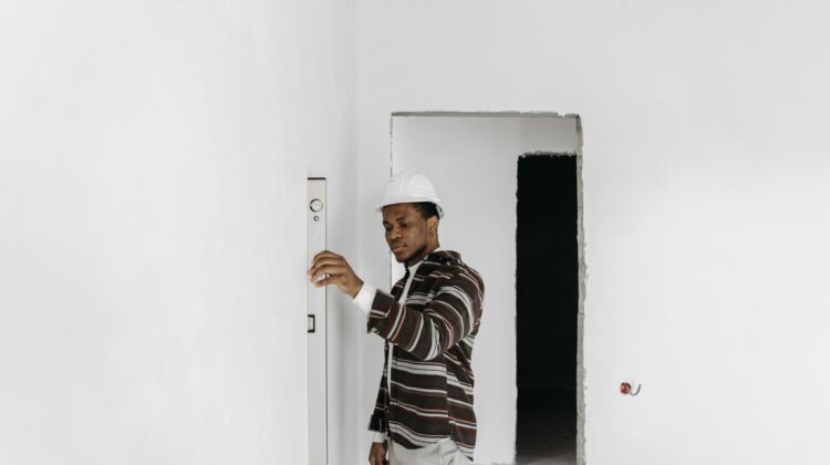 Office renovation site inspection with project manager overseeing construction and blueprint