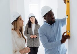 Project manager overseeing office fitouts with blueprint and risk management focus