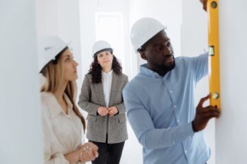 Project manager overseeing office fitouts with blueprint and risk management focus
