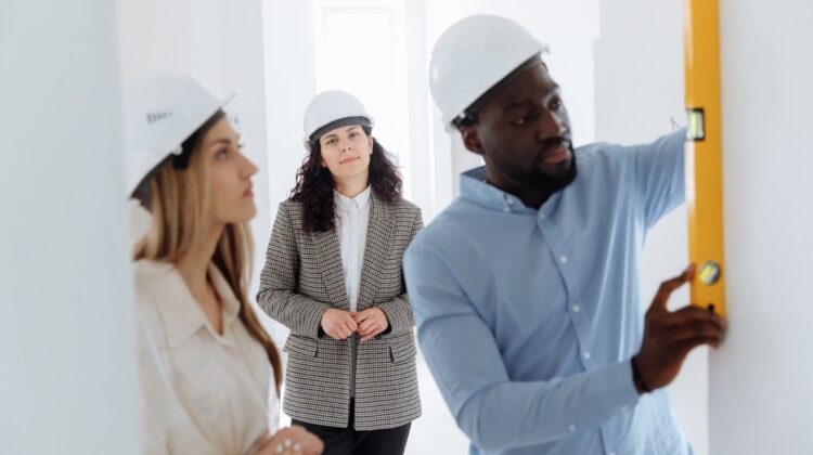 Project manager overseeing office fitouts with blueprint and risk management focus